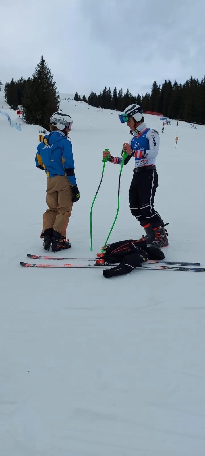 Kevin Schmidle talking with his coach on the slope